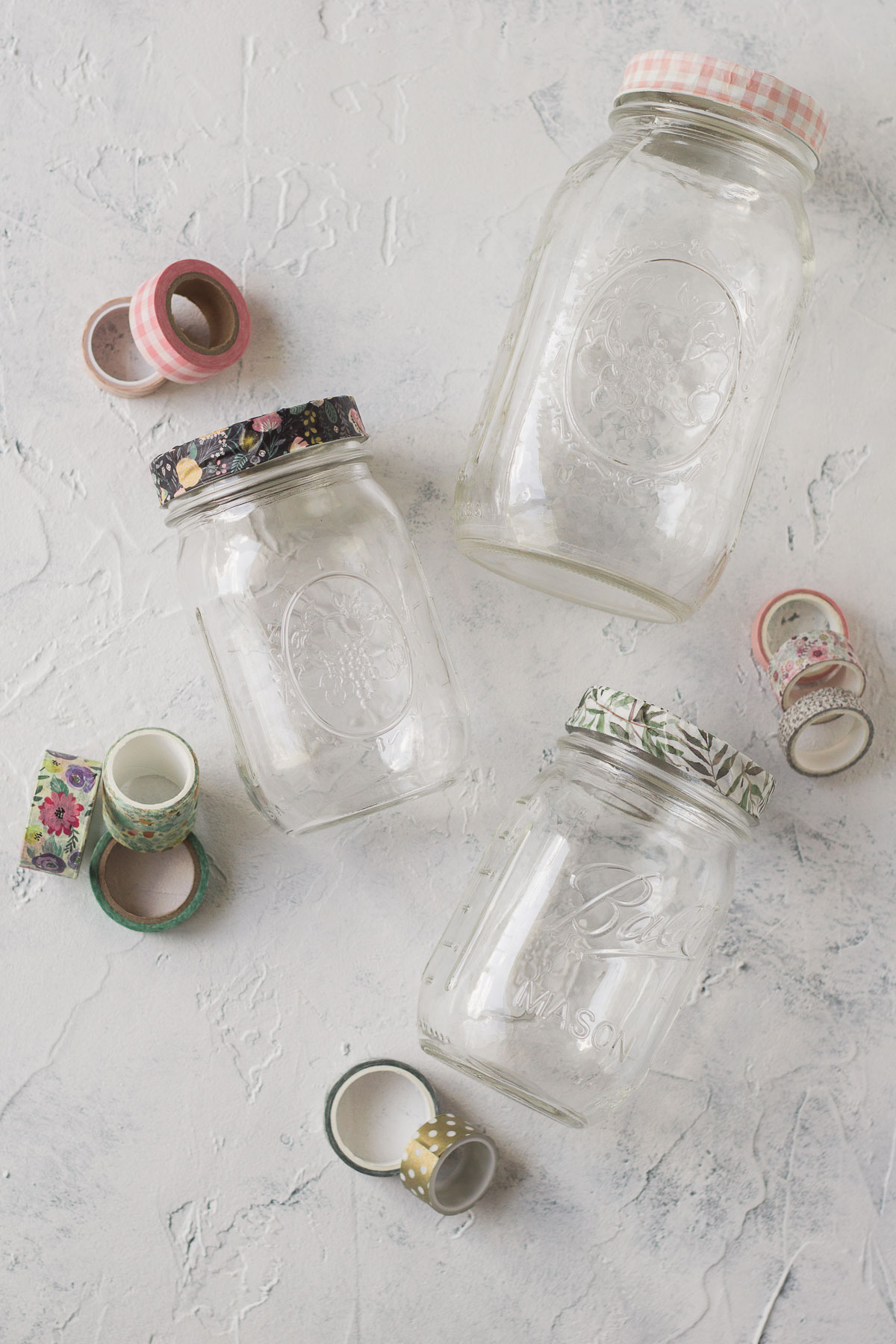 Three glass jars decorated with washi tape.