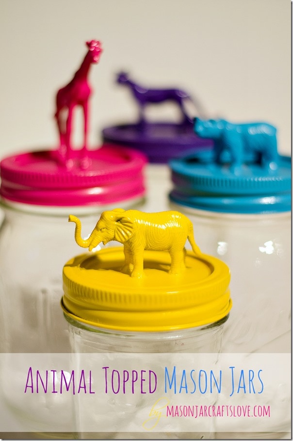 Mason jars topped with plastic animals and spray painted yellow, pink, blue, and purple.