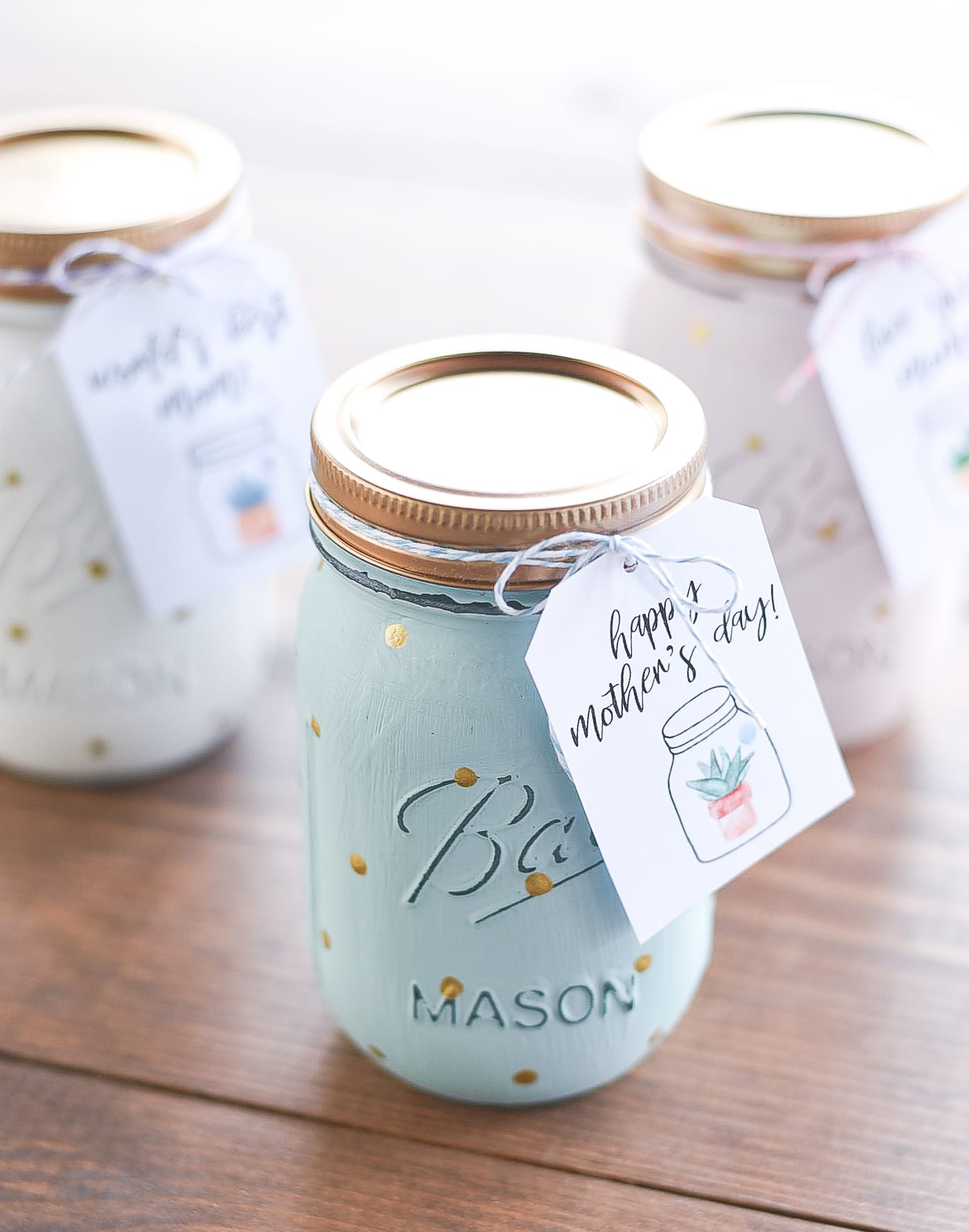 A painted blue mason jar with a tag that reads, "Happy Mother's Day!"