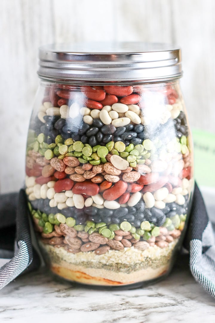 Layers of beans and spices in a large jar for a homemade gift.