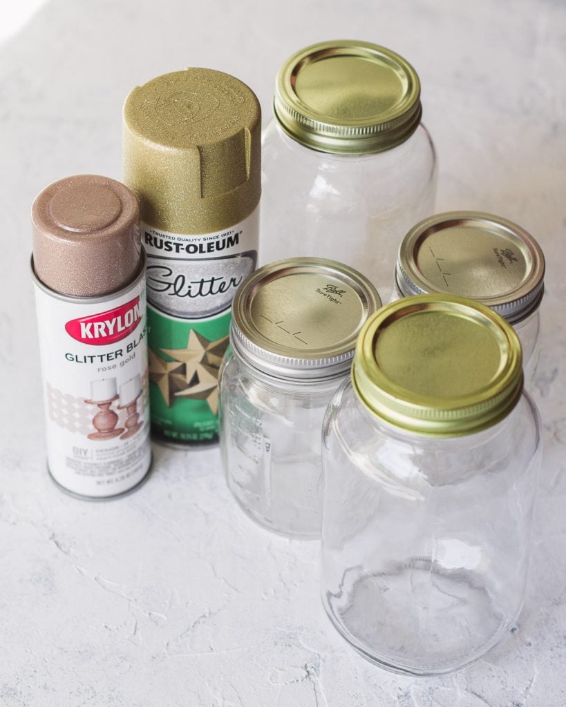 A selection of glass jars and glitter spray paints.