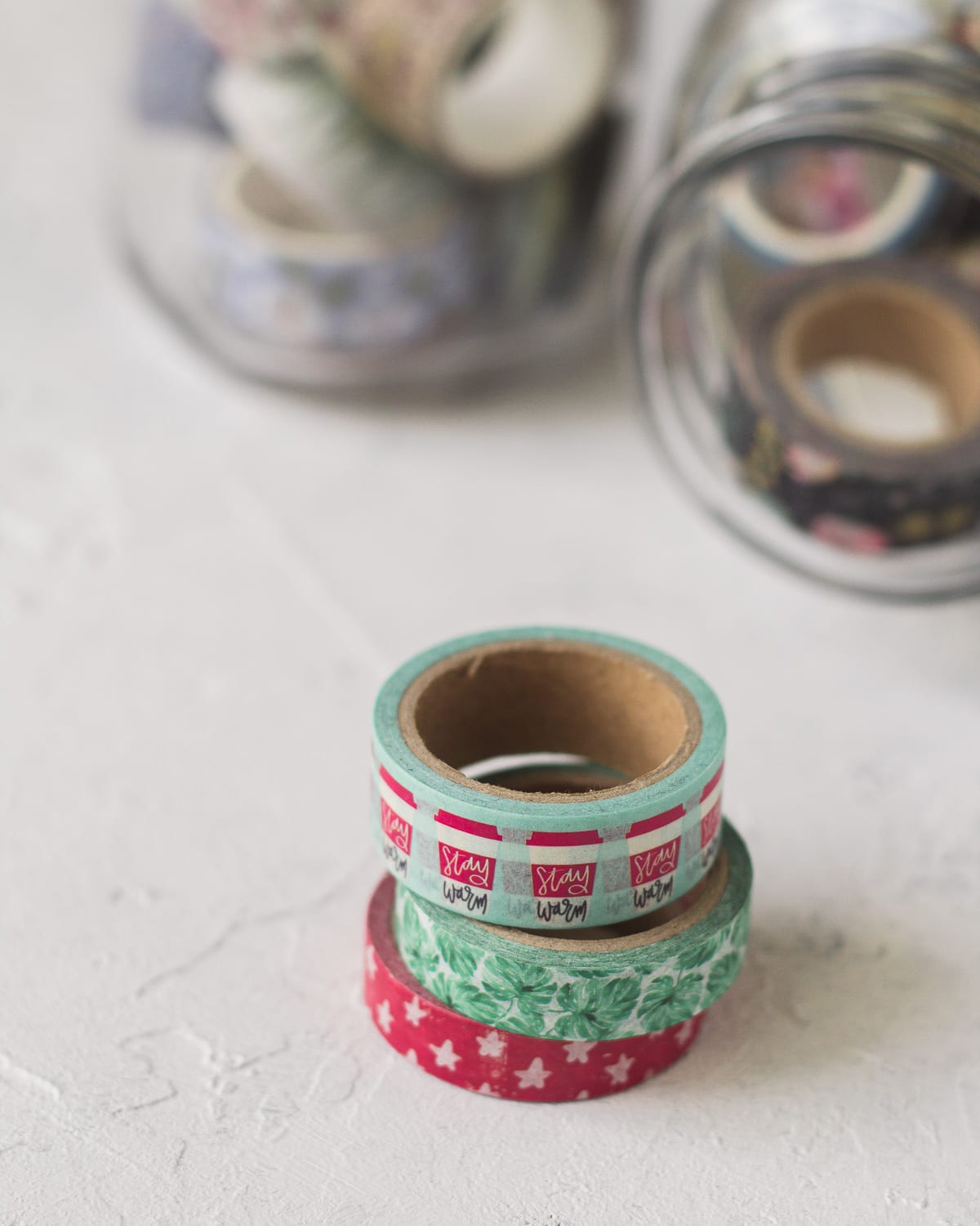 Colorful washi tape spools in a stack.