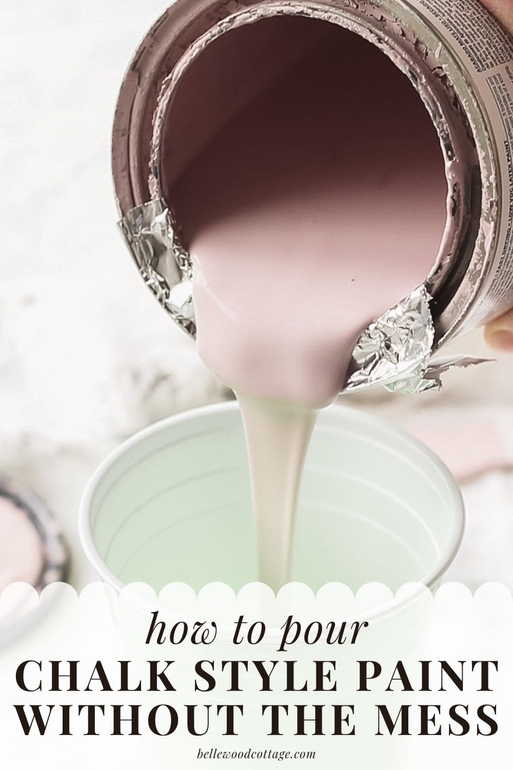 Pink chalk paint being poured into a cup.