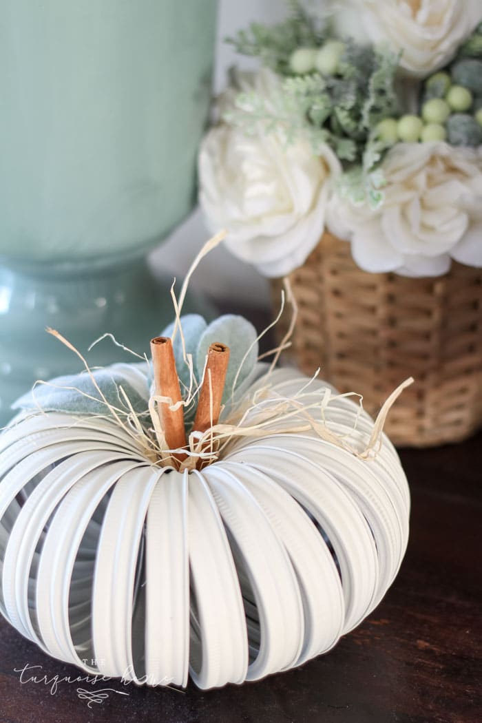 A DIY pumpkin made with mason jar lids.