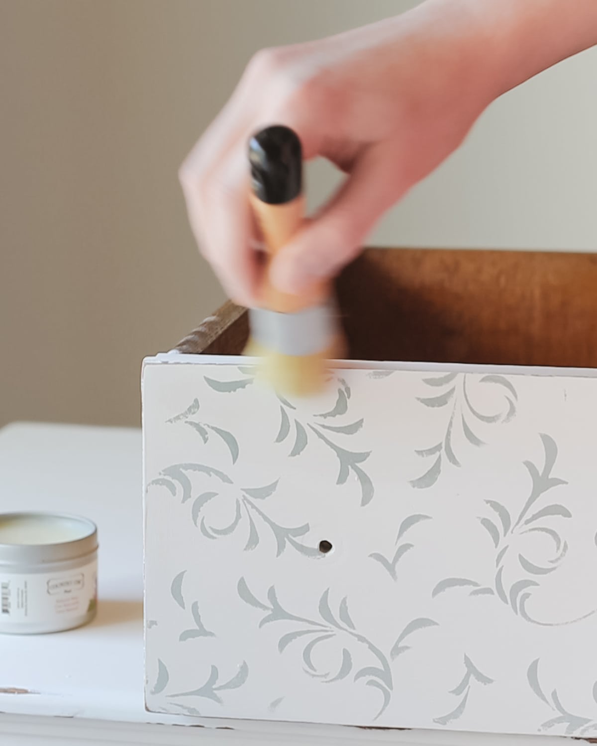 Waxing a dresser drawer.