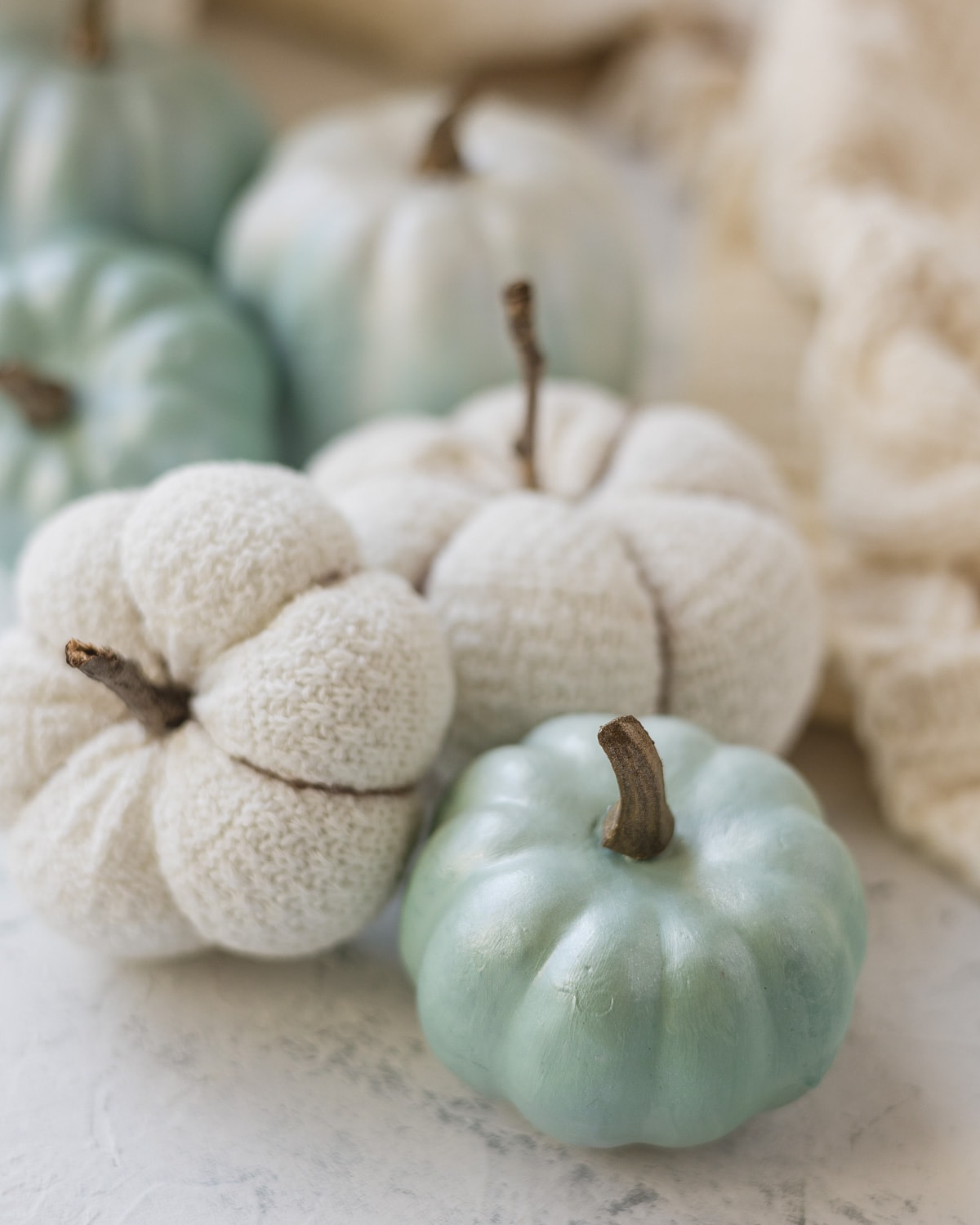 A light blue faux pumpkin and DIY sock pumpkins.