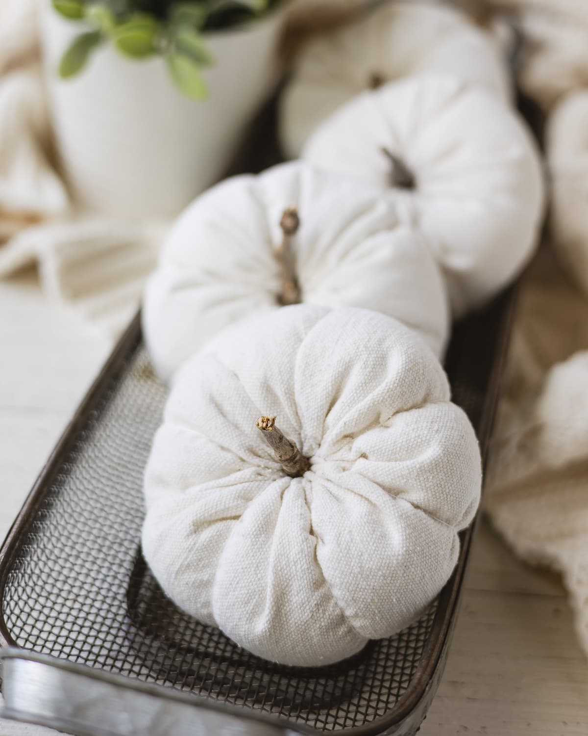 DIY drop cloth pumpkins in a wire basket.