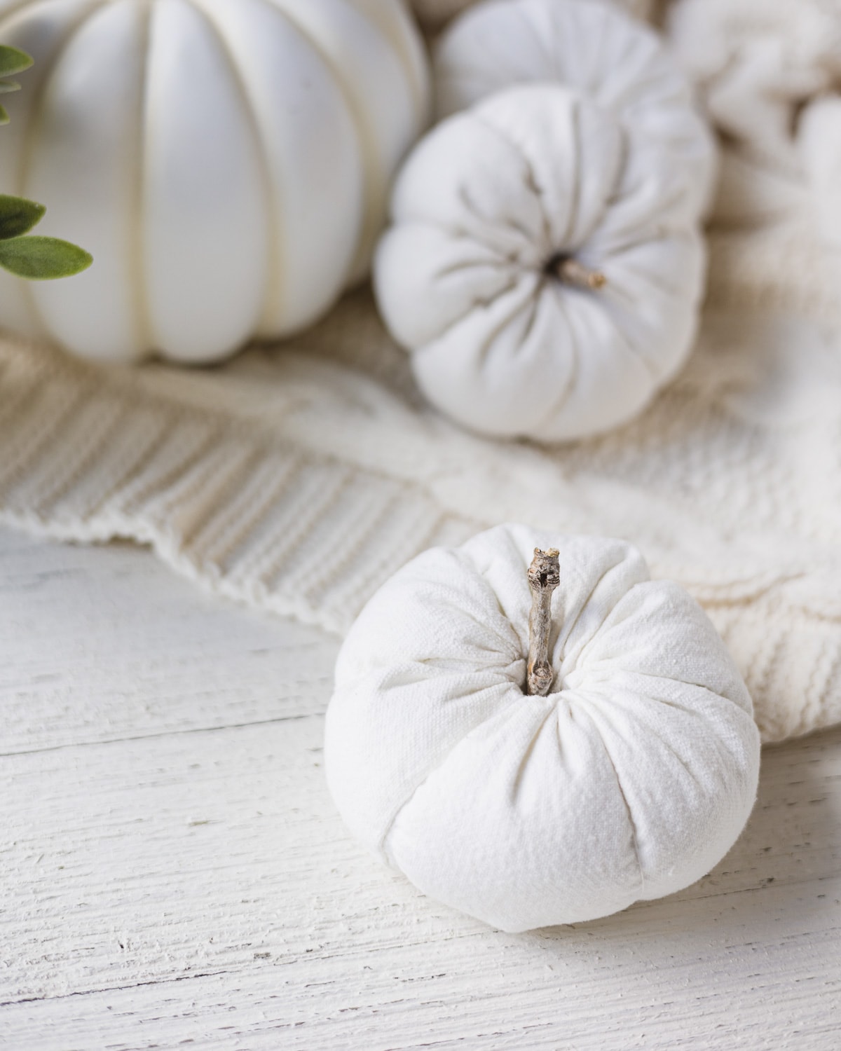 DIY drop cloth pumpkin on a wooden surface.