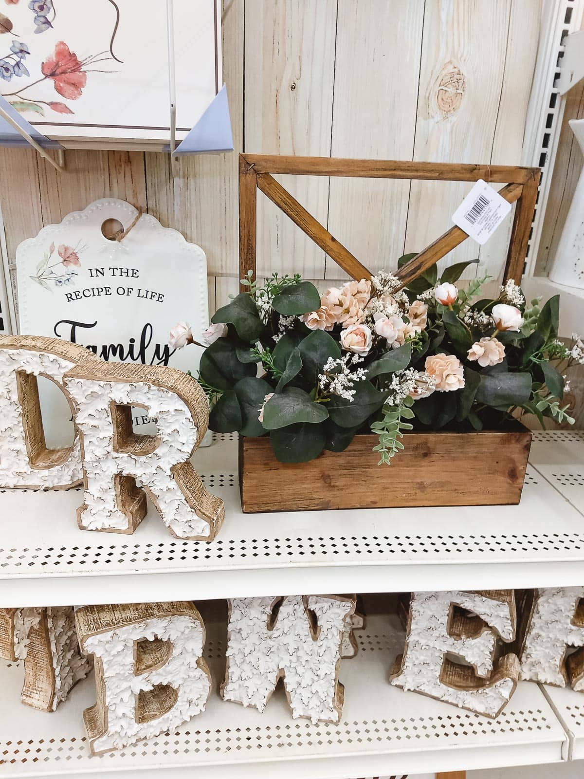 Fall monogram letters and a large fall faux flower arrangement.