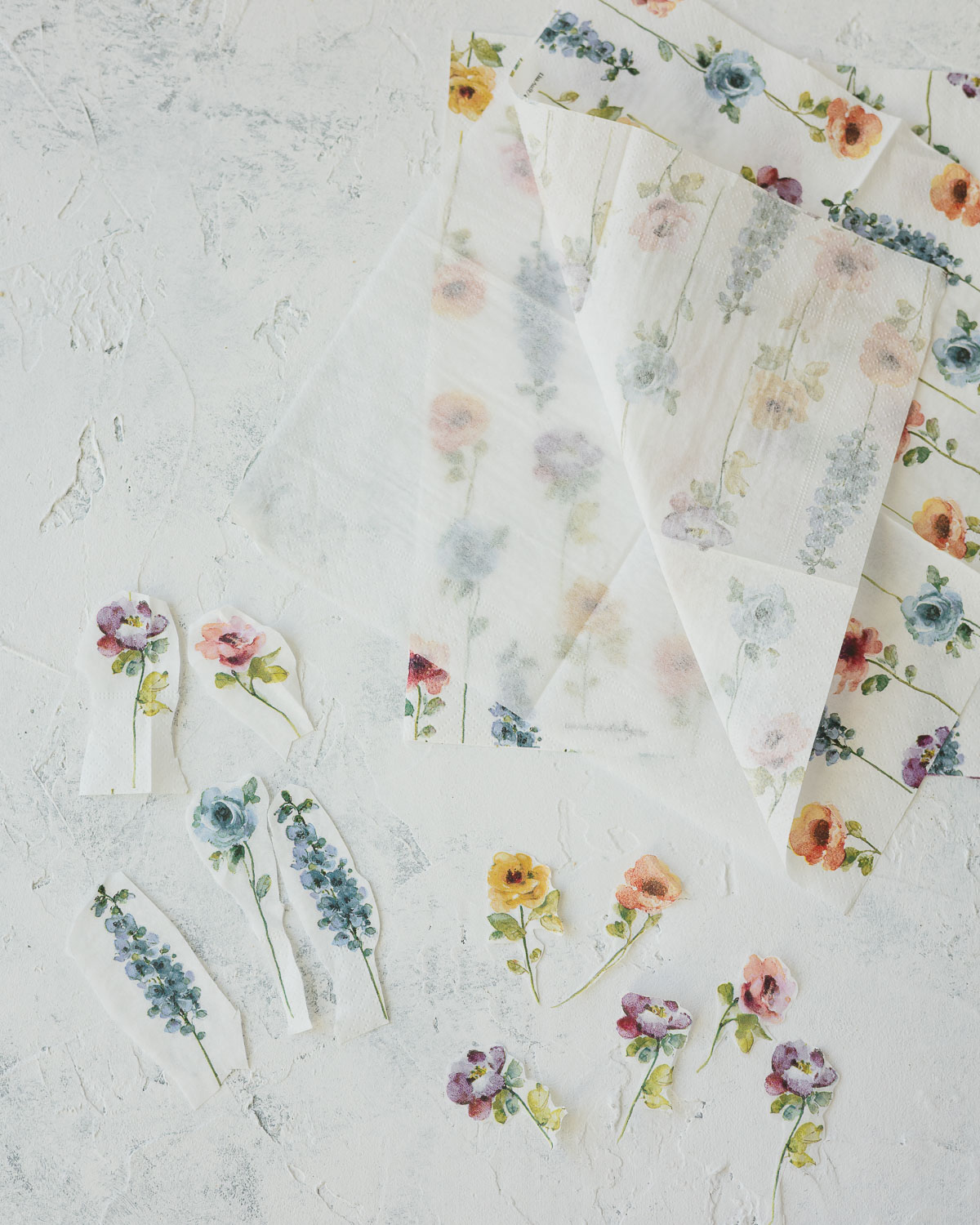 Floral paper napkin surrounded by cut-outs.