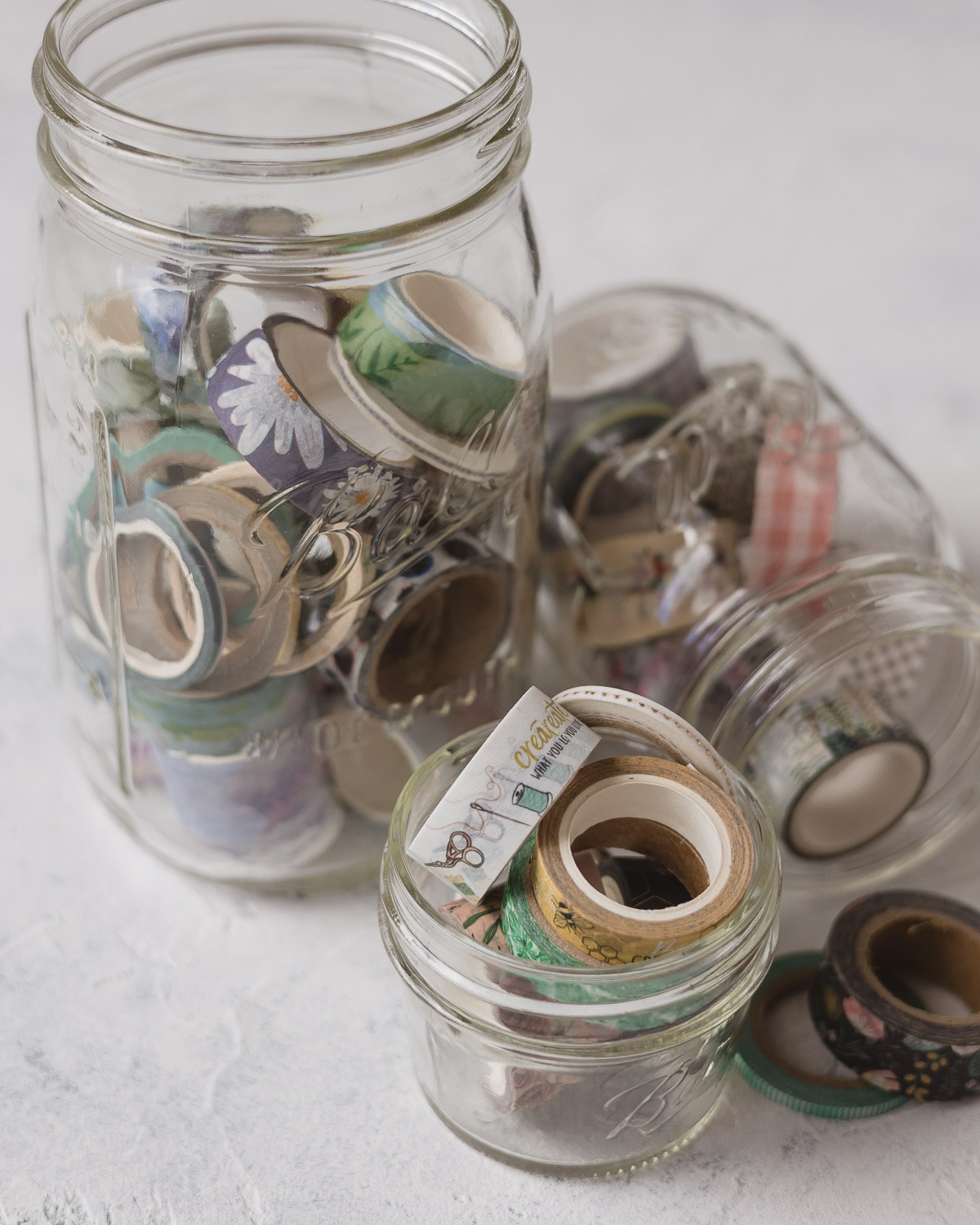 Mason jars filled with colorful washi tape.