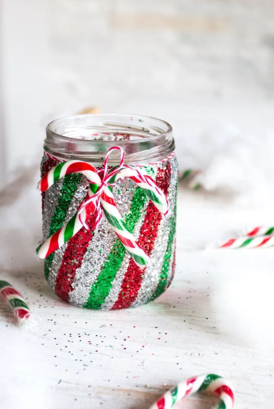 A red, green, and silver striped glitter mason jar.