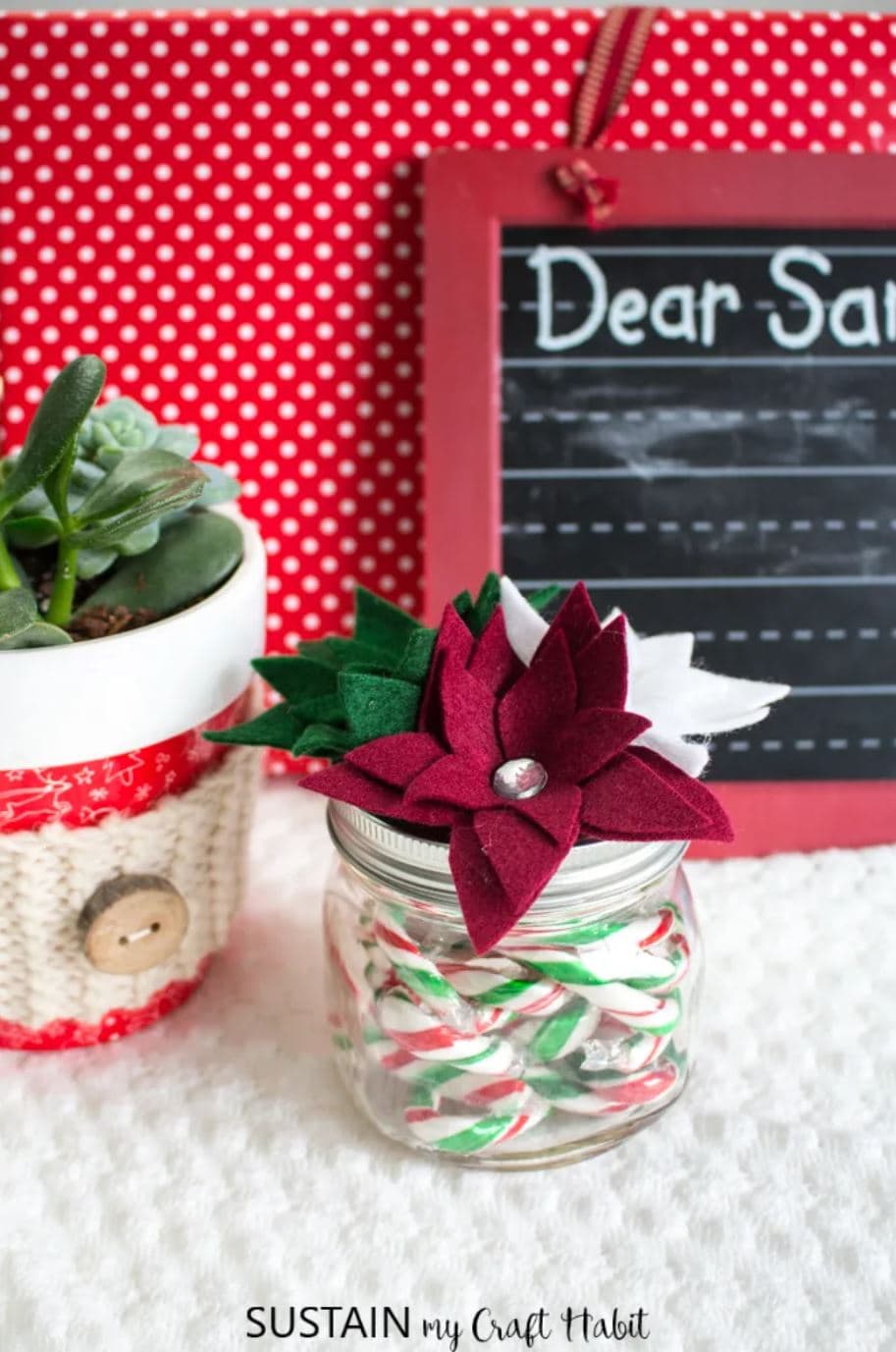 A glass jar topped with a handmade Christmas poinsettia.