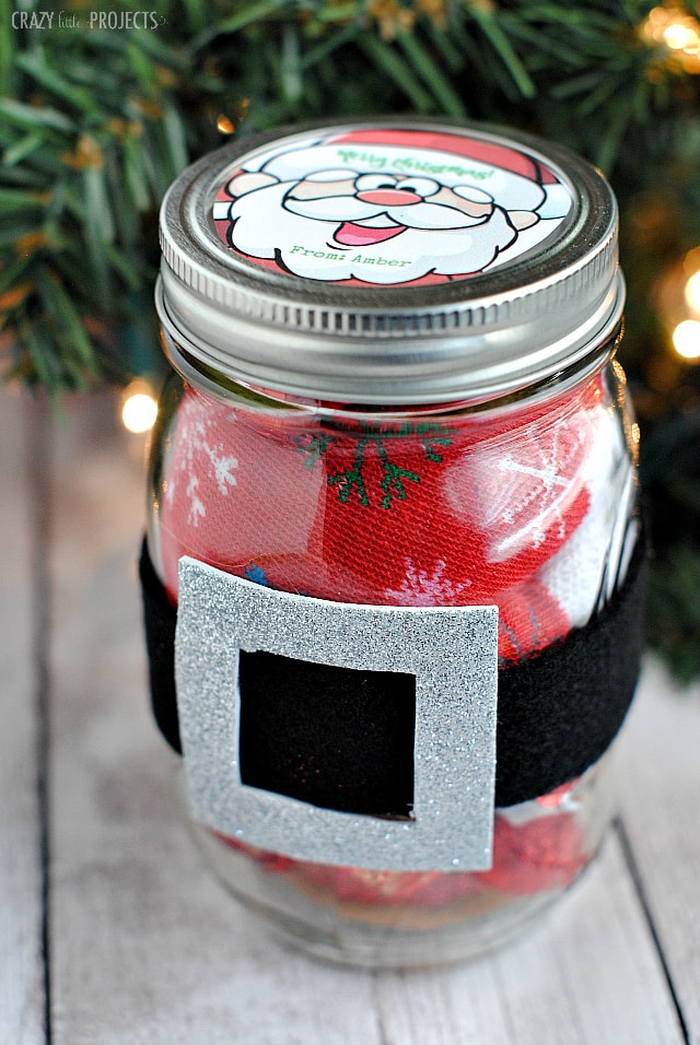 Glass decorated with red fabric and a Santa belt.