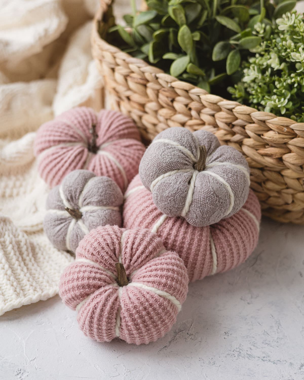 Pink and light purple sweater pumpkins with faux pumpkin stems.