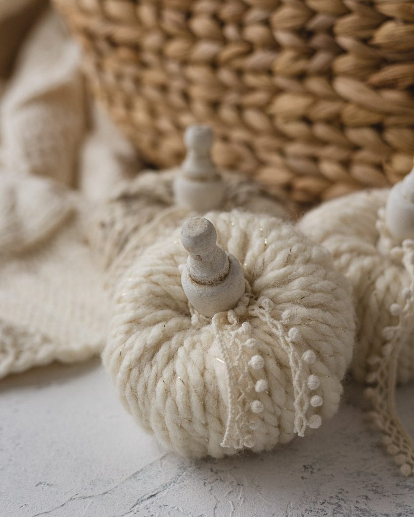 Yarn wrapped pumpkins with wooden stem and lace detail.