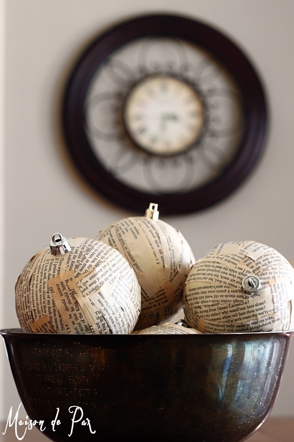 Three ornaments covered with scraps of book pages.