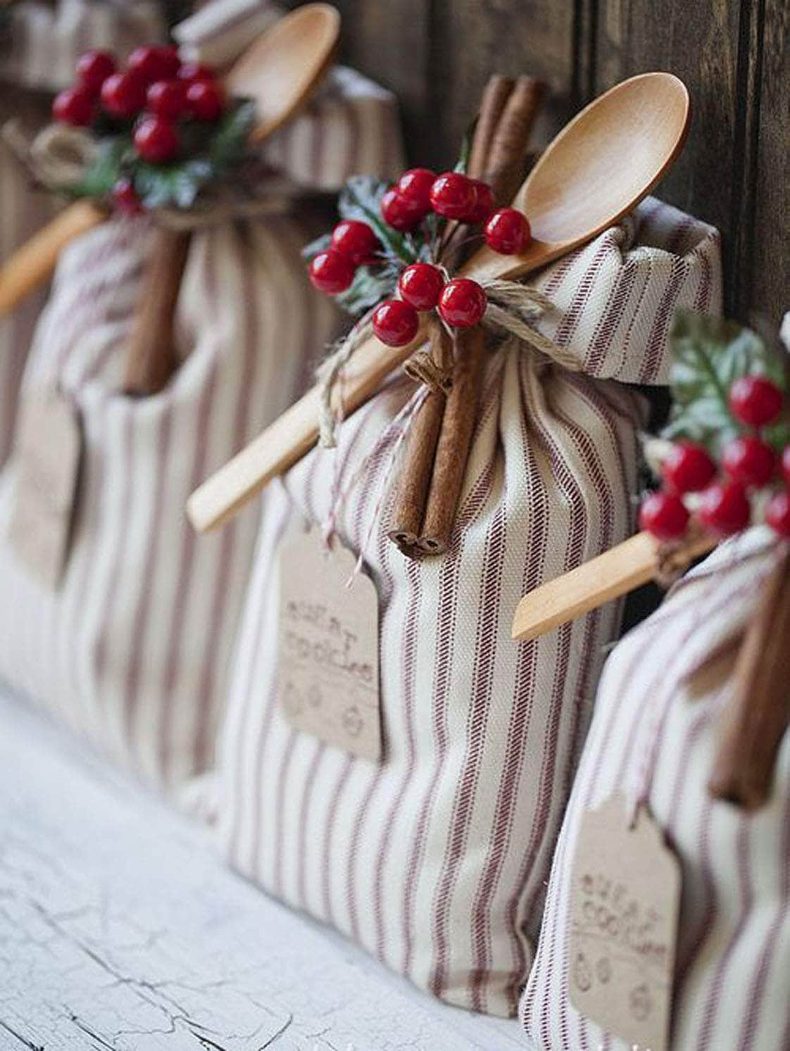 Ticking stripe gift sacks with tags and cinnamon stick embellishment.