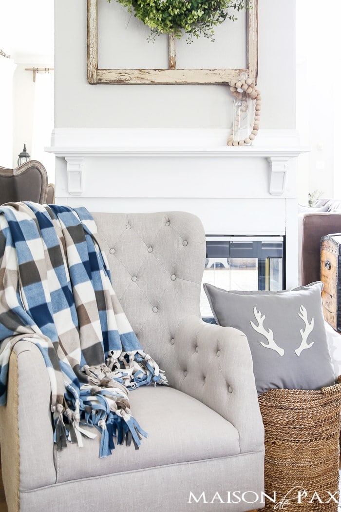 A fleece throw blanket on a gray chair.