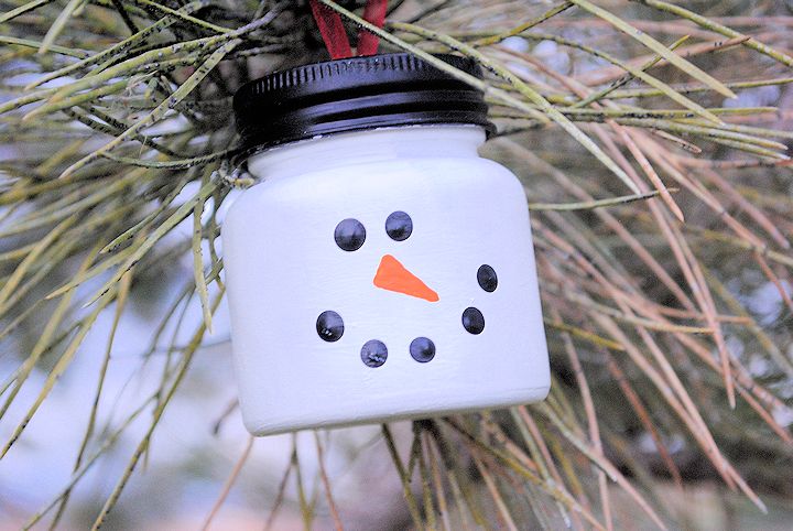 A baby food jar painted to look like a snowman.