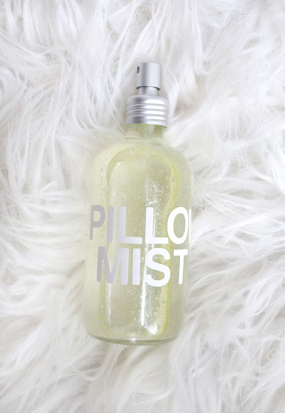 A bottle reading "pillow mist" on a fluffy white backdrop.