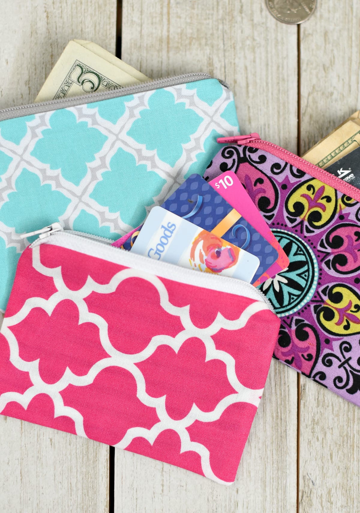Three colorful zipper pouches with gift cards.