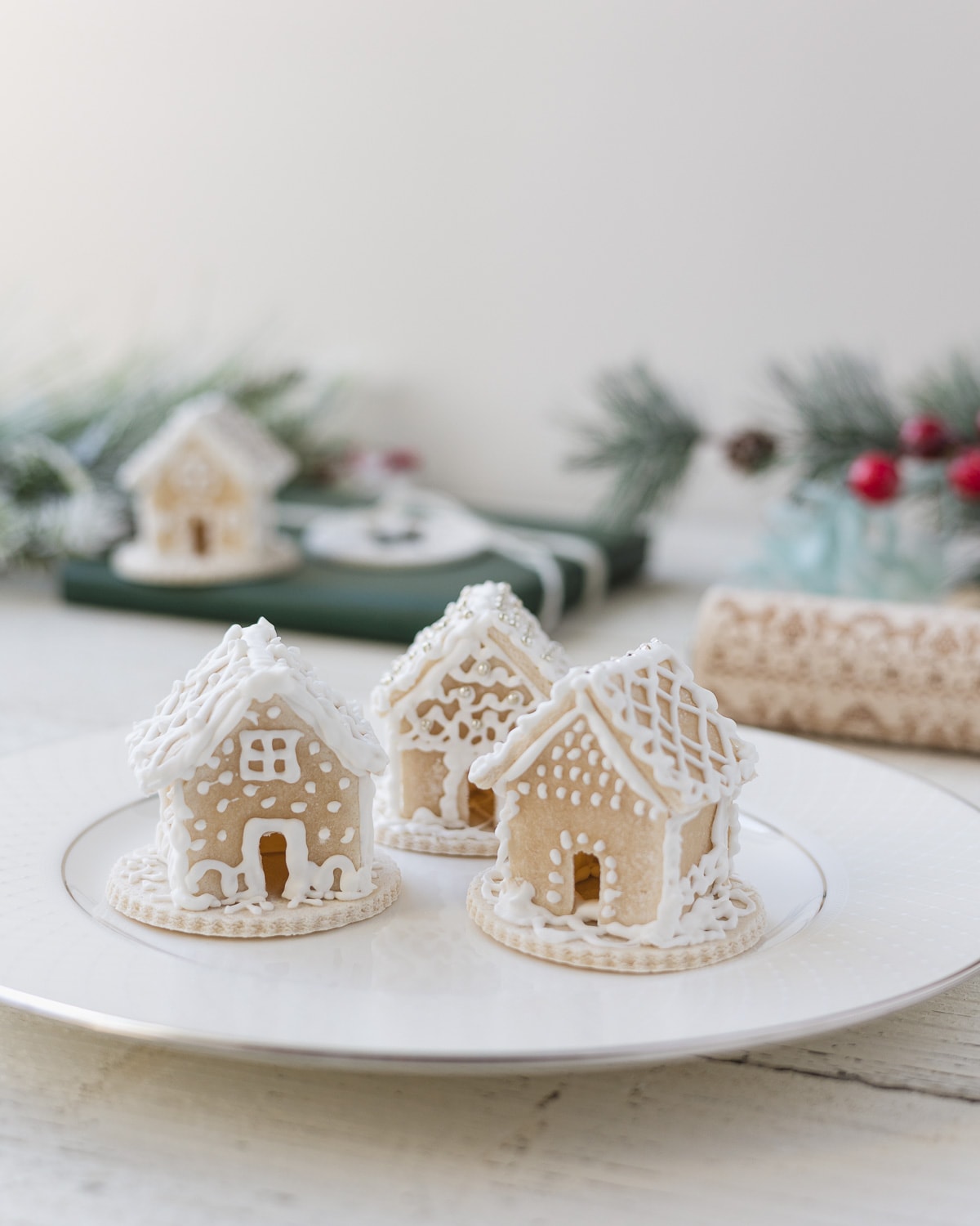 Three miniature salt dough gingerbread houses with royal icing.