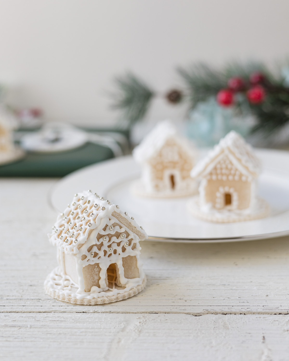 A miniature gingerbread house decorated with sparkly seed beads.