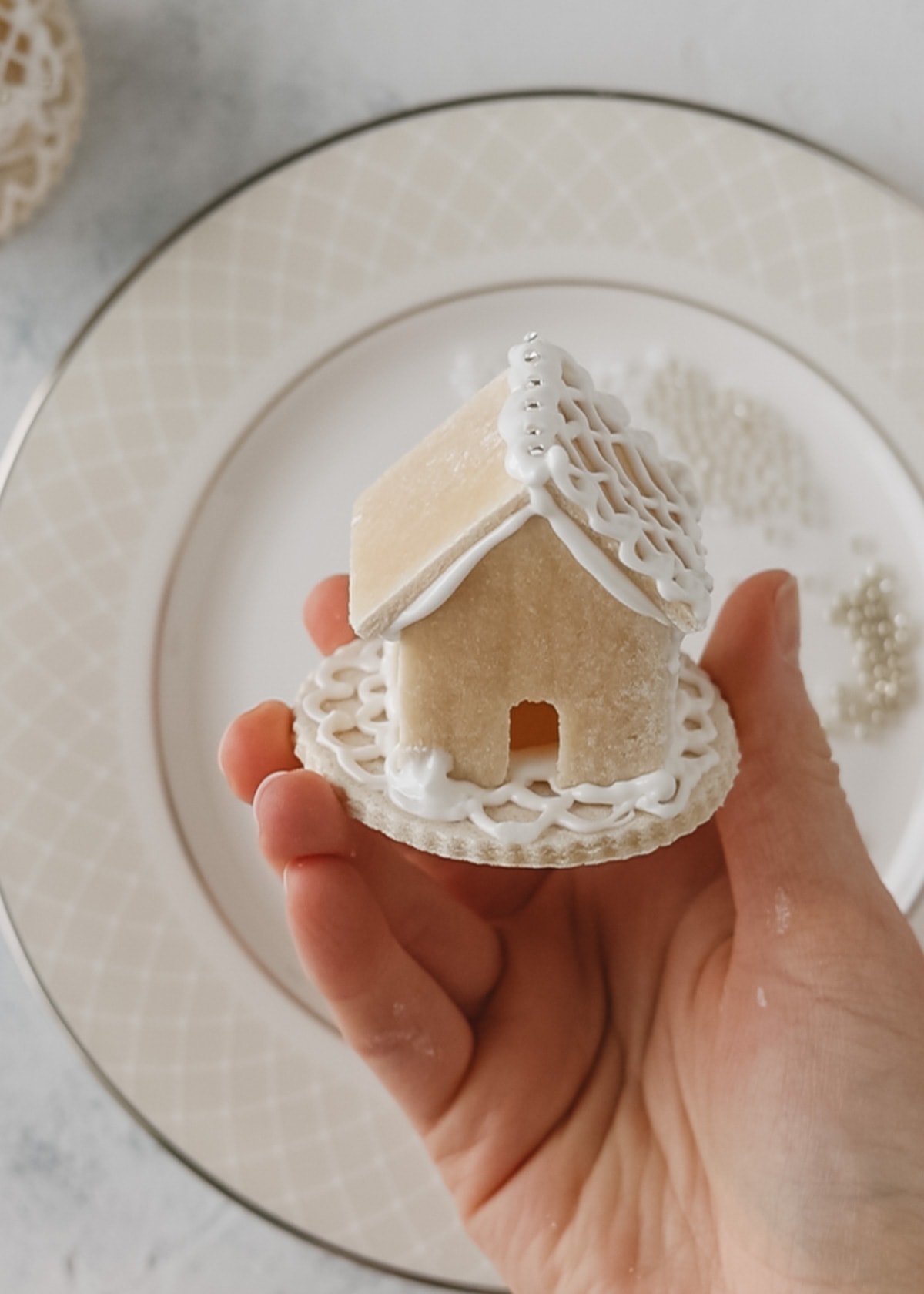 Holding a partially decorated mini salt dough house.