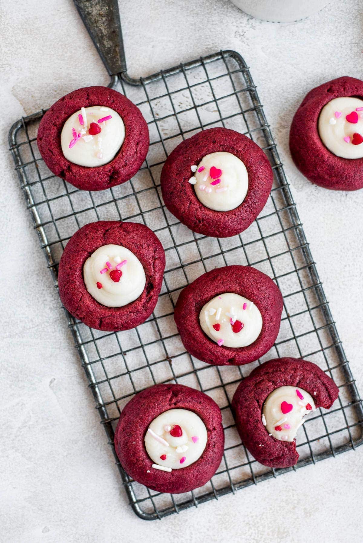 Red Velvet Thumbprint Cookies on a cooling rack.