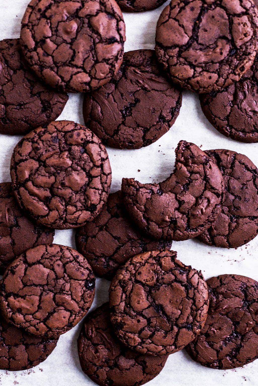 Chocolate brownie cookies on parchment.