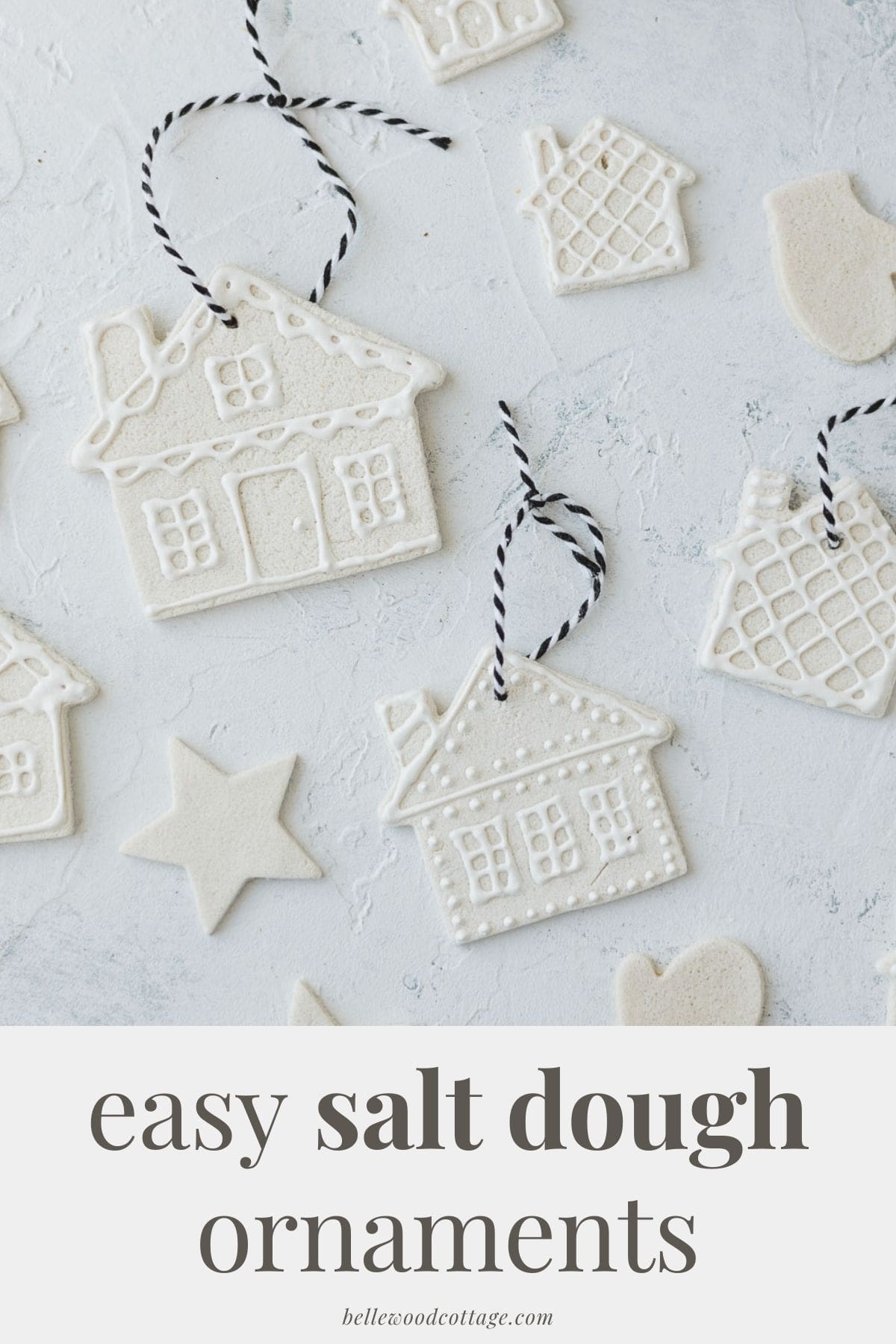 Salt dough houses decorated with white puffy paint with the words, "Easy Salt Dough Ornaments".