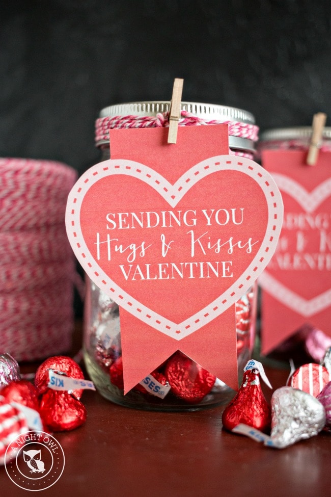 A jar filled with chocolate kisses with a gift tag reading, "Sending You Hugs & Kisses Valentine".