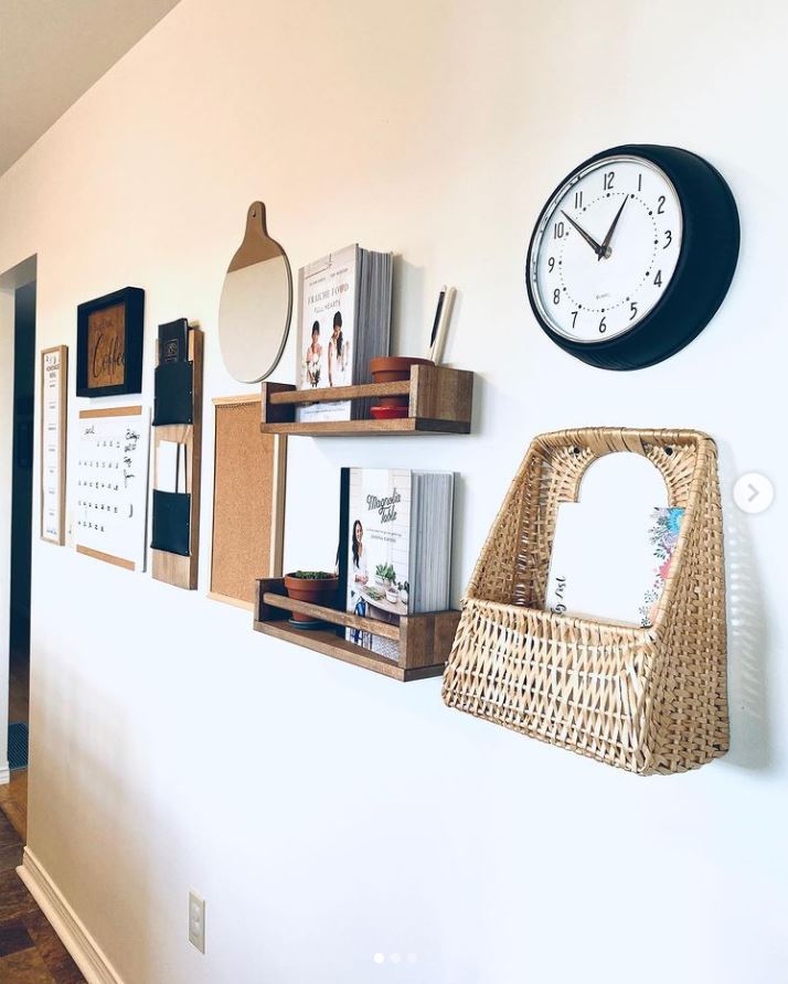 A wall command center with calendar, shelving, clock, and baskets.