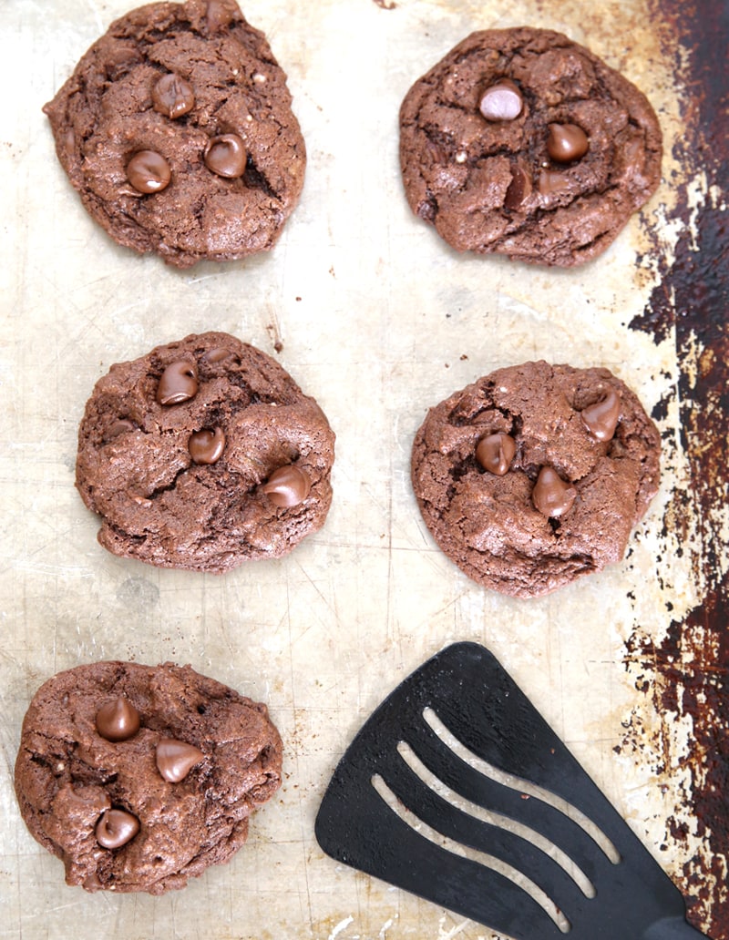 A sheet pan of chocolate cake mix cookies with chocolate chips.
