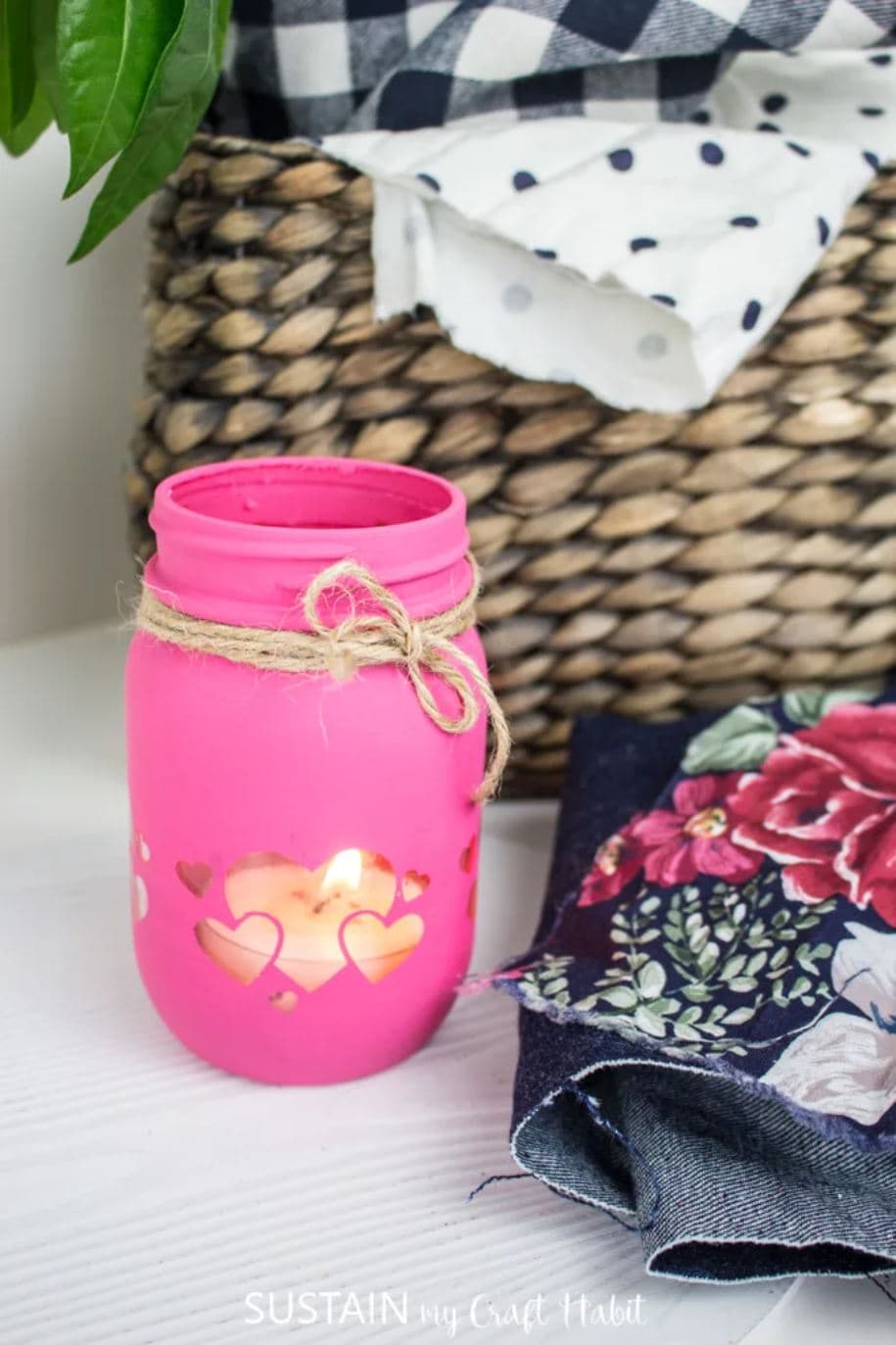 A pink painted mason jar candle holder.