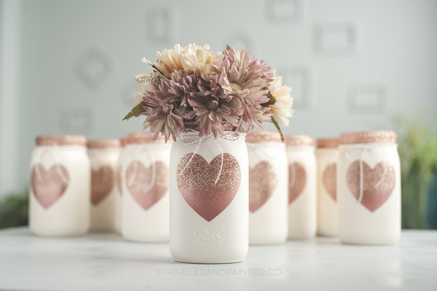 Glitter heart mason jars filled with florals.