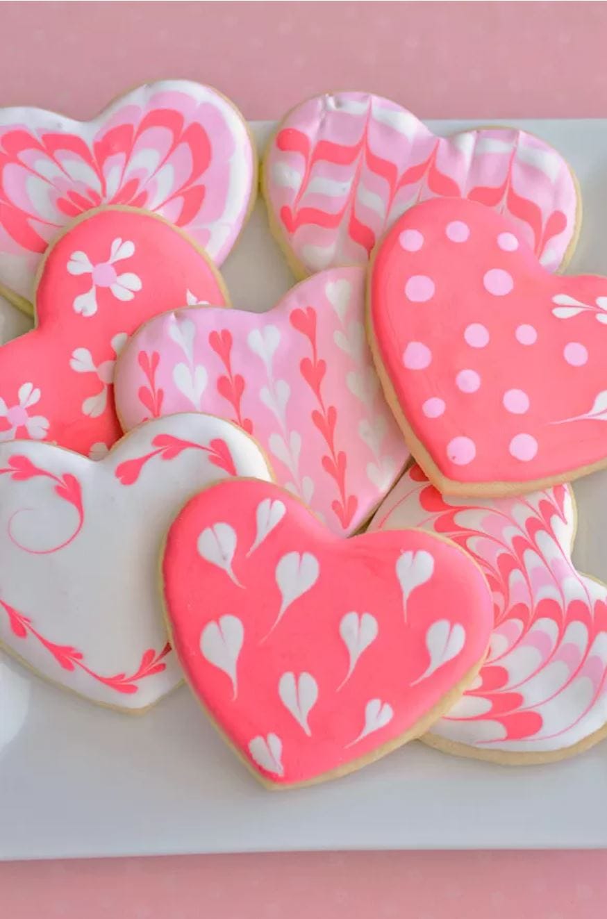 Valentine's Day Heart Cookies decorated with pink royal icing in heart patterns.