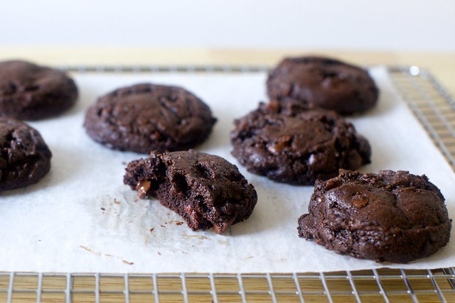 Brownie cookies on a parchment-lined cooling rack.