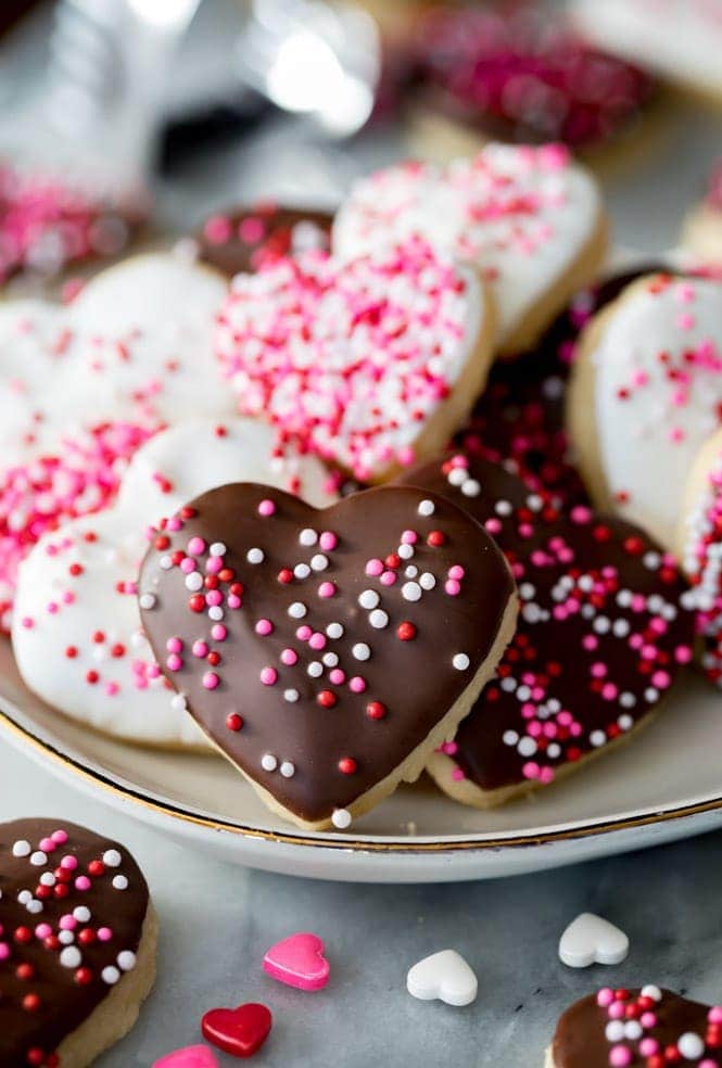 Valentine's Sugar Cookies frosted with white and chocolate frosting and topped with nonpareils sprinkles.