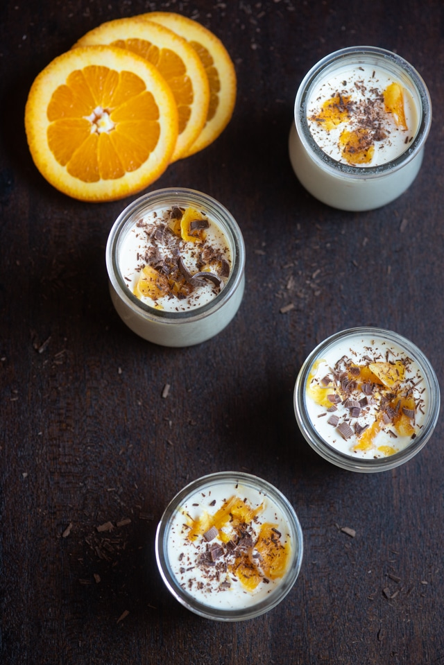 Small glass jars filled with orange and chocolate possets.