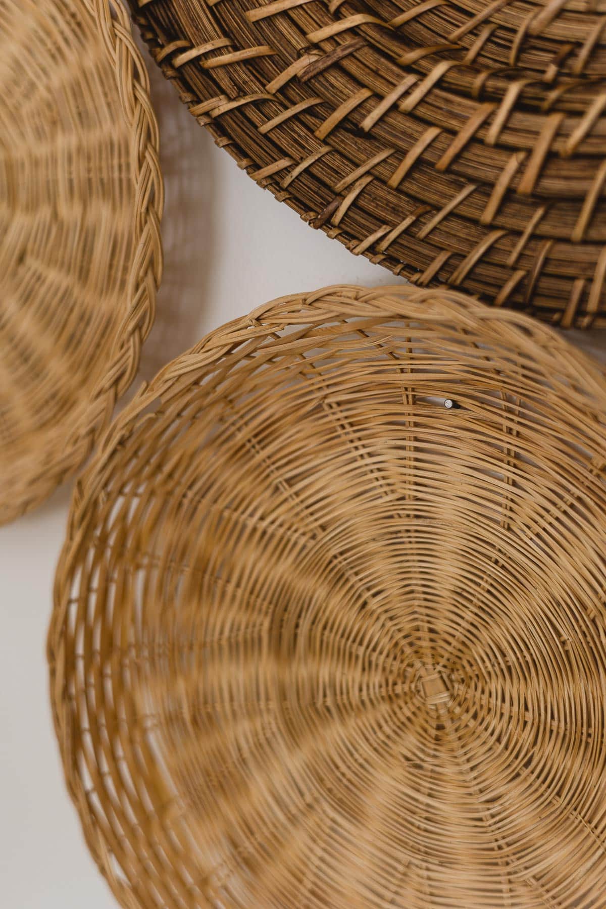 Closeup of a nail nailed into a basket to hang it on the wall.