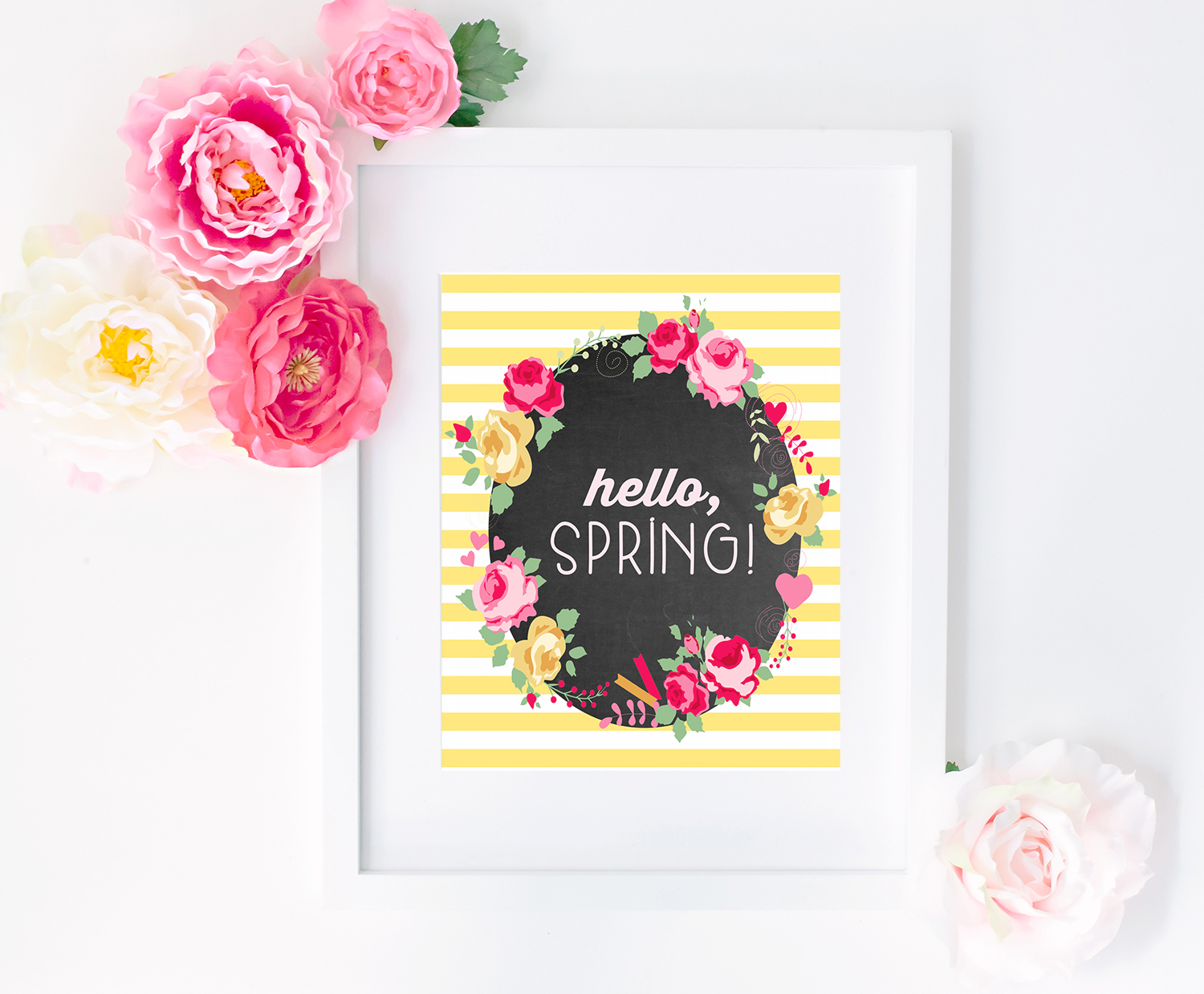 A framed picture of "Hello Spring" words and florals.