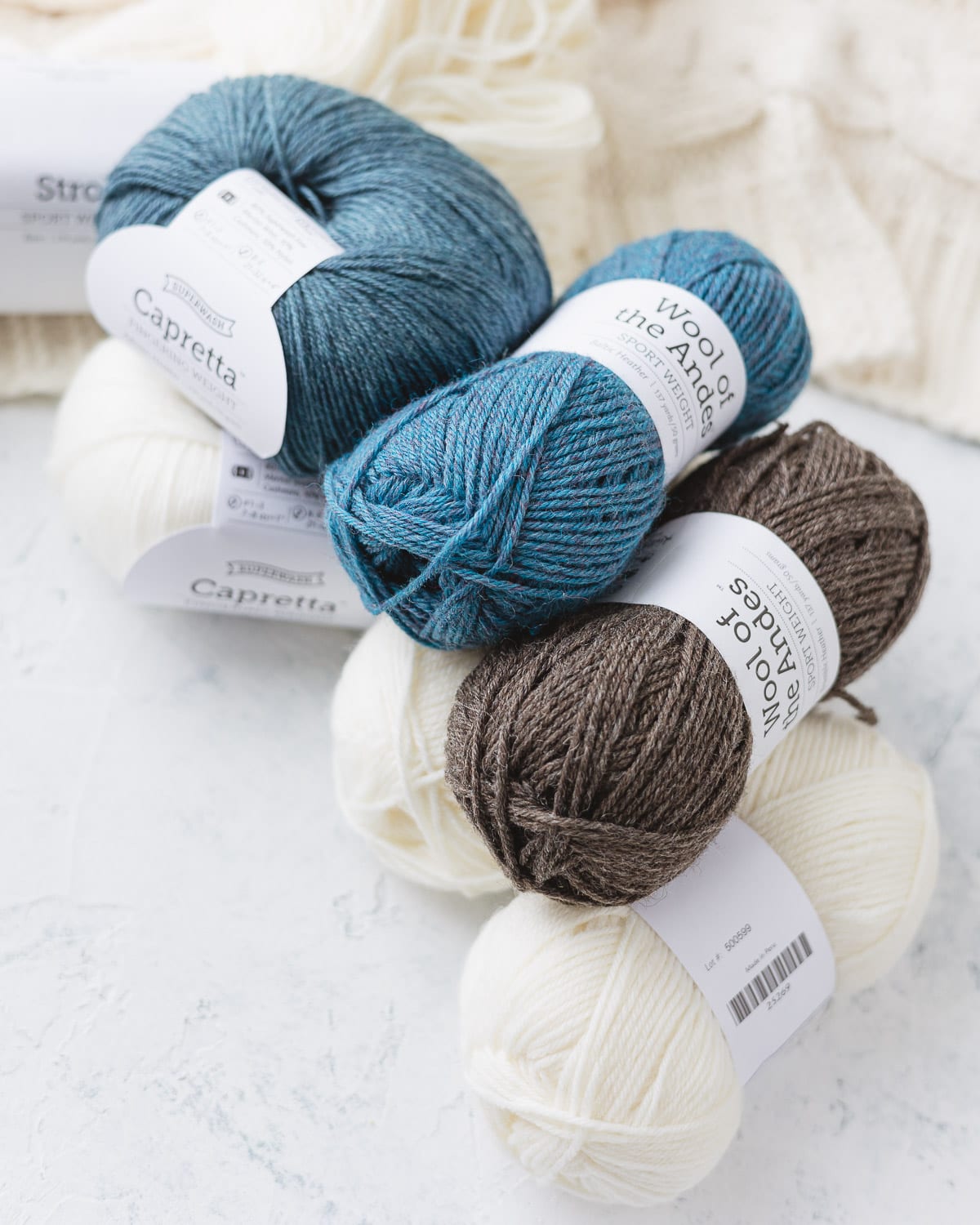 A selection of blue, cream, and brown yarn from Knit Picks.