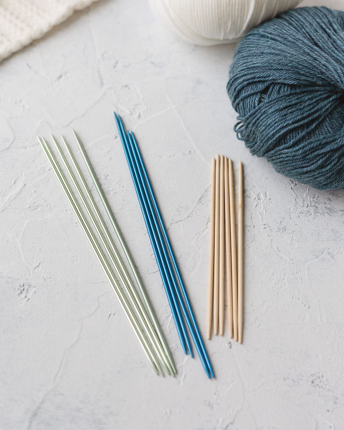 Three sets of double-pointed knitting needles.
