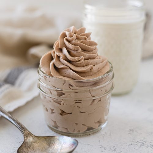Nutella whipped cream piped into a mason jar with a vintage spoon.