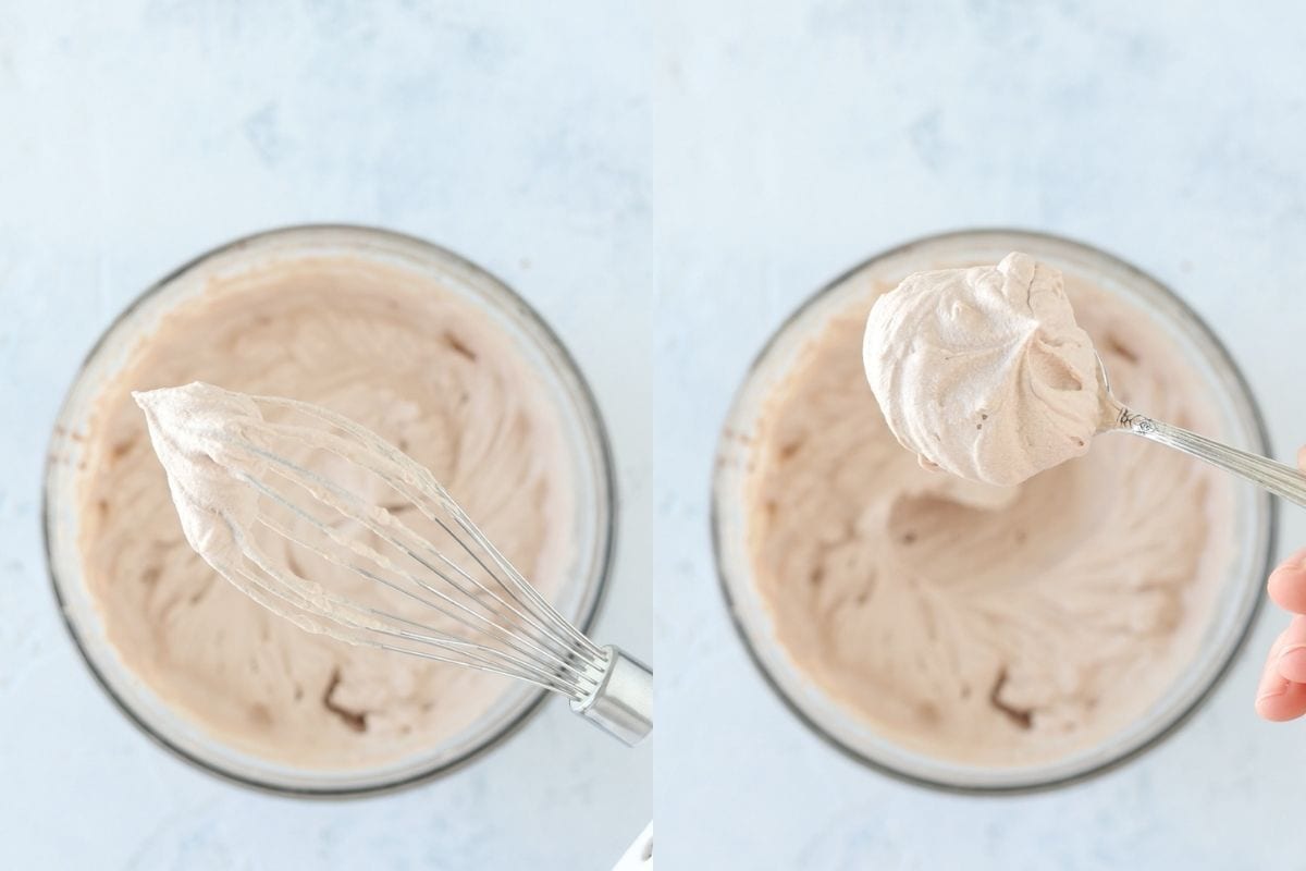 Whisk attachment of a hand mixer and a spoon demonstrating stiff peaks of whipped cream.