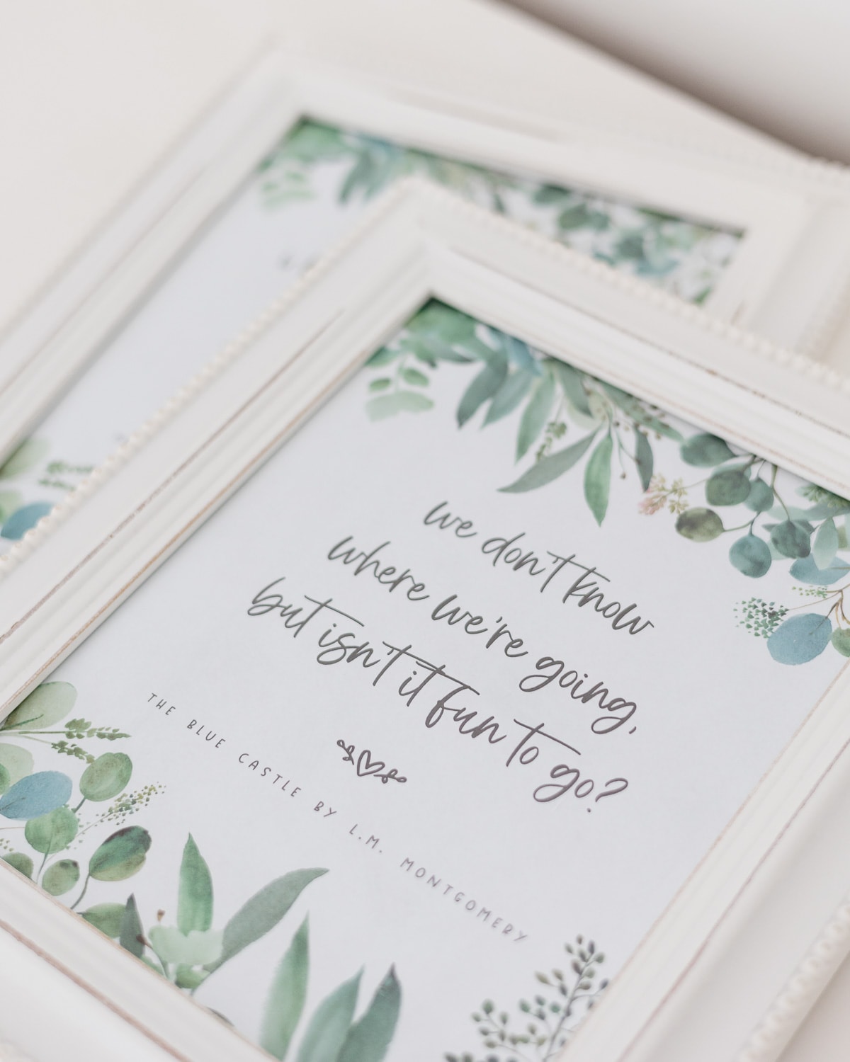 A quote from L.M. Montgomery's The Blue Castle framed in a white frame.