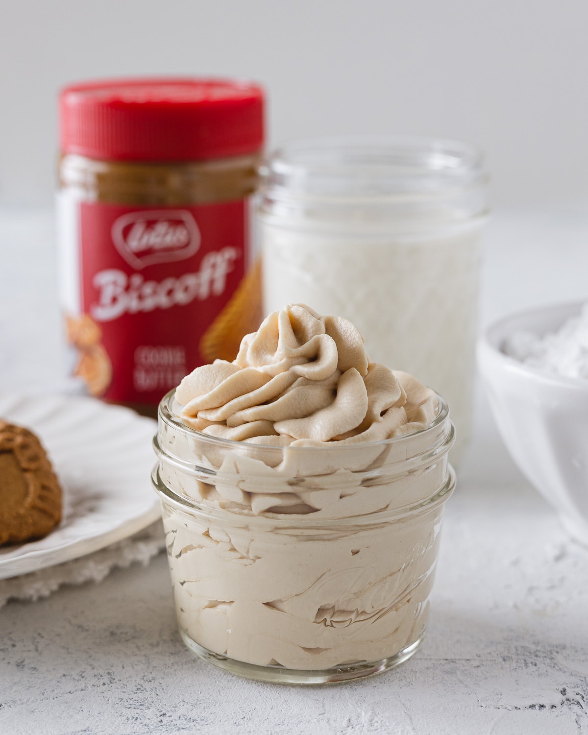 Whipped cream made with Biscoff spread and piped into a small glass jar.