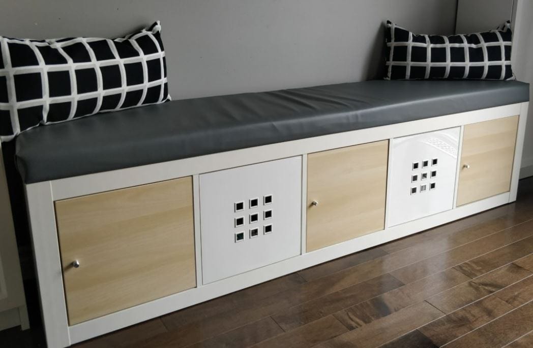 A storage bench with a faux leather seat cushion made with an IKEA Kallax shelf.